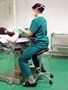 Surgeon using a Salli Saddle Chair with Elbow Rest arm support